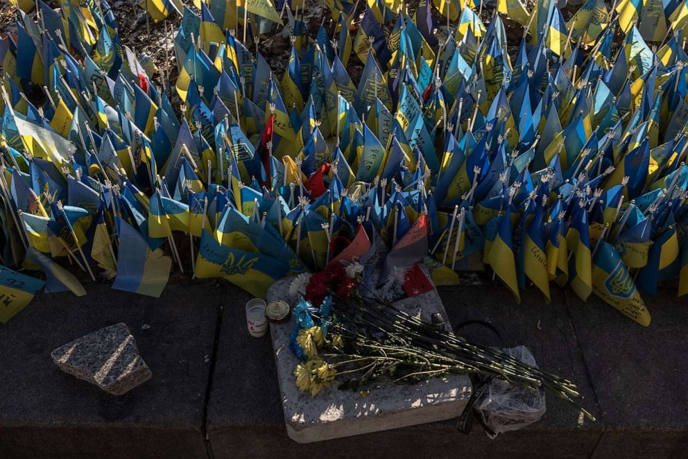 Ukrainian flags planted at a memorial in Kyiv