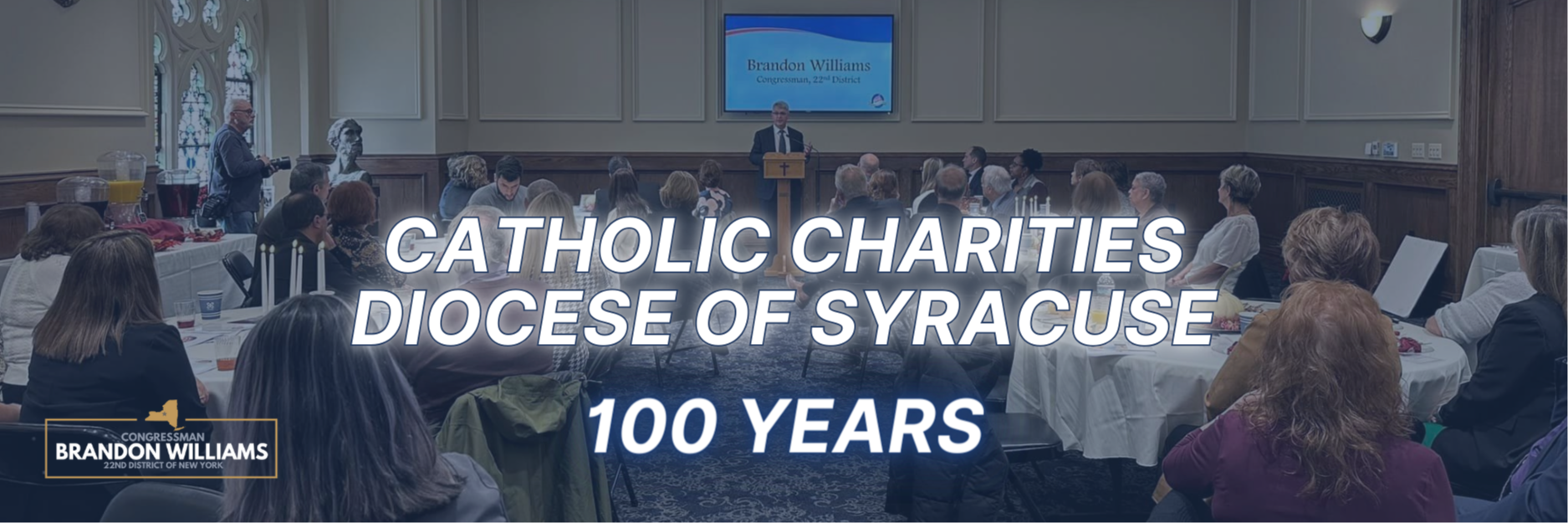 Rep. Williams presents Congressional Record to Catholic Charities of Syracuse